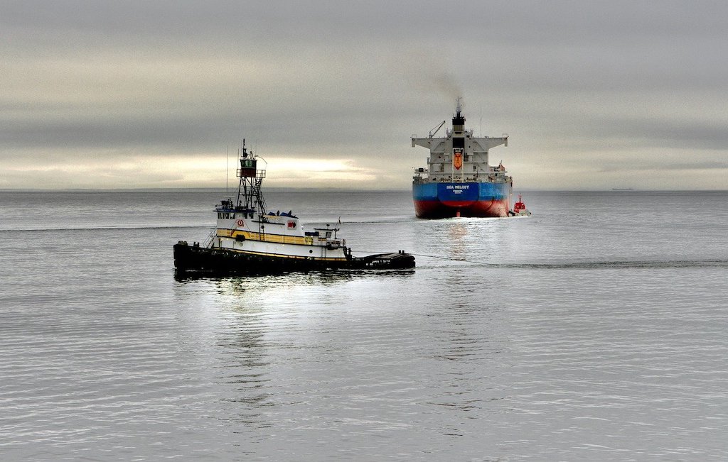 Tug boats work to free giant container ship stuck in Suez Canal