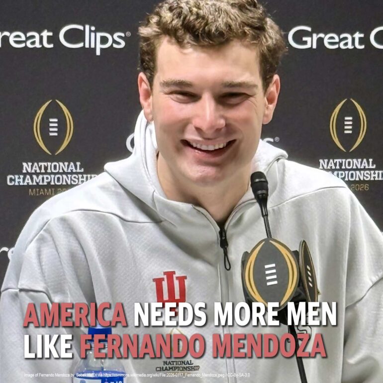 Smiling man in a gray hoodie at a press conference with a National Championship backdrop, text on image reads 'America Needs More Men Like Fernando Mendoza'.