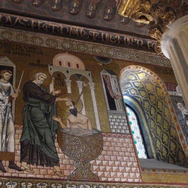Mosaic of Jesus's baptism: John pours water over Jesus in a decorative church wall scene with bystanders and patterned tile floor.